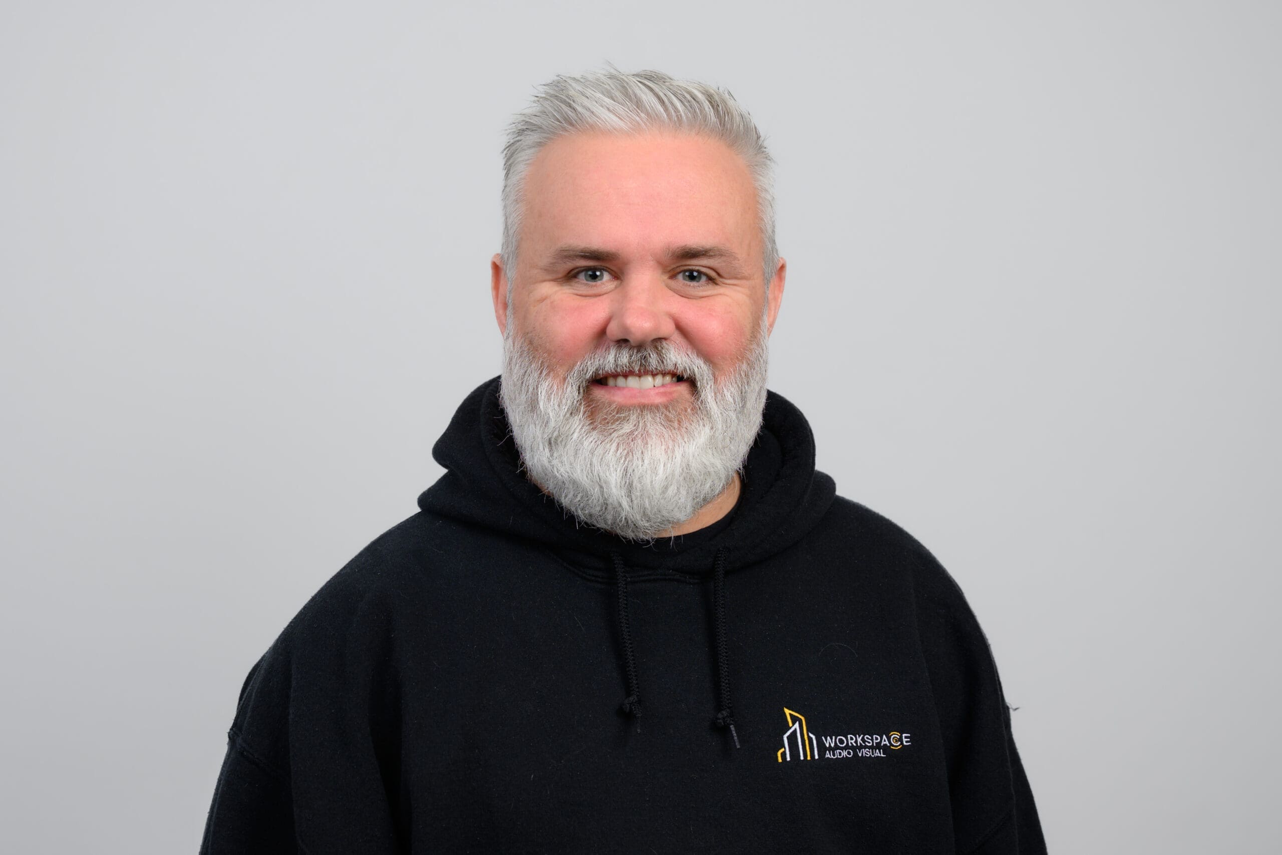 man with a white beard wearing a black hoodie